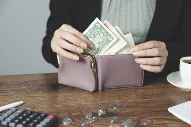 woman hand money with wallet on the desk - 写真・画像