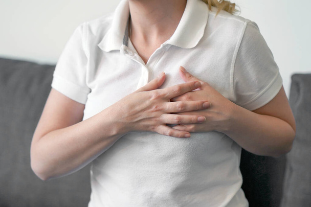 Woman having heart attack. Girl, hurts the heart. Woman having chest pain - heart attack. - Photo, Image