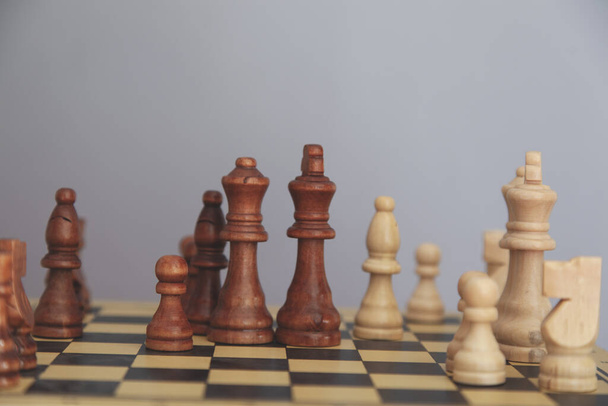 chess on the board on the grey background - Фото, зображення