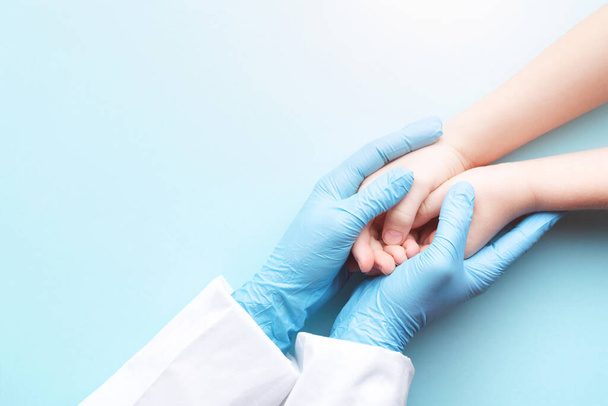 Doctors hands holding childs hands. - Фото, зображення