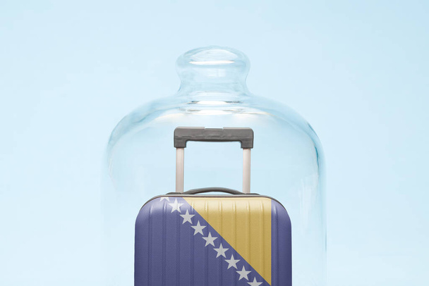 Suitcase with Bosnia and Herzegovina flag design in quarantine minimal creative coronavirus travel restriction concept. - Photo, image