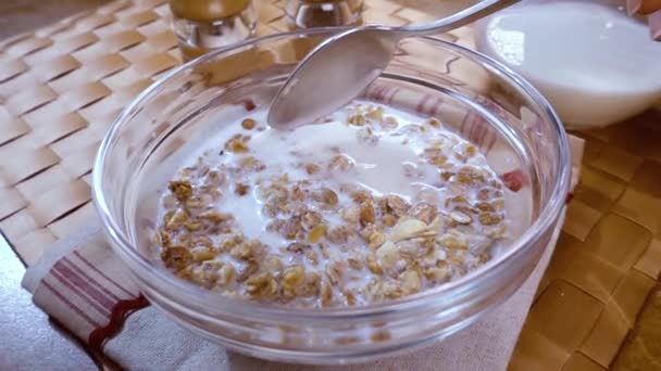 Whole grain cereal muesli in a bowl for a morning delicious breakfast with milk. Slow motion with rotation tracking shot. - Materiaali, video