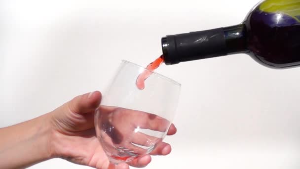 Red wine being poured into glass in slow motion - Video