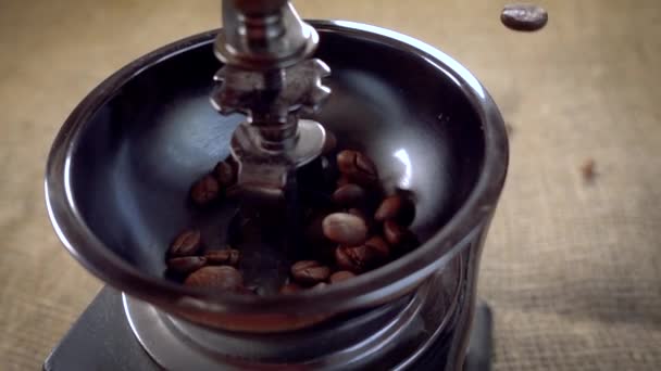 Coffee beans fall in the old grinder. Slow motion with rotation tracking shot. - Footage, Video
