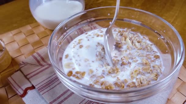 Whole grain cereal muesli in a bowl for a morning delicious breakfast with milk. Slow motion with rotation tracking shot. - Footage, Video