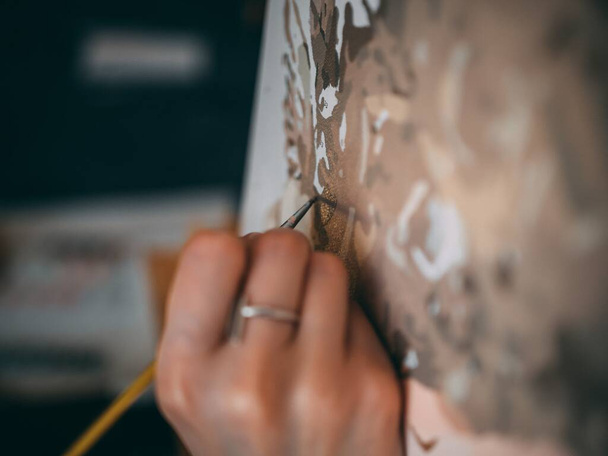 A selective focus shot of an artist painting on the canvas - Zdjęcie, obraz