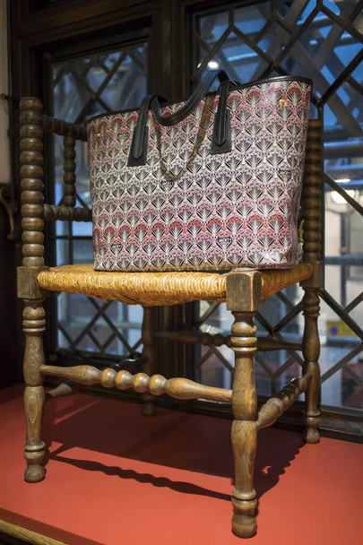 London, UK - 15 February, 2020, rattan chair with a leather bag in a window in a Liberty store on Regent Street - Foto, Imagen