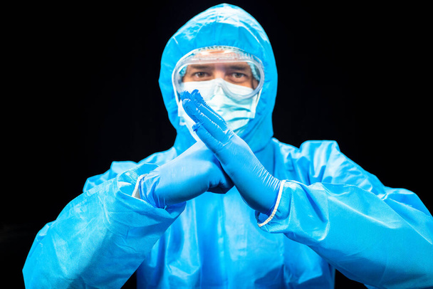 The fight against the virus. A man in a protective antivirus suit. - Φωτογραφία, εικόνα