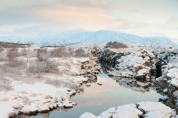 Thingvellir National Park Iceland snow covered mountains and rocky terrain - Photo, Image