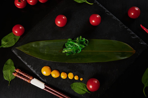 Traditional Japanese food - sushi, rolls and sauce on a black background. Top view. - 写真・画像