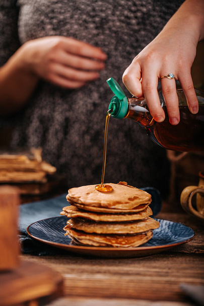 American pancakes with delicious mapple syrup on old wood table on a blue plate - Valokuva, kuva