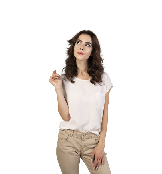 Isolated portrait of dreamy pensive young woman with wavy dark hair in smart casual clothes looking upwards - Photo, Image