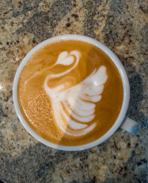 Swan latte art on cafe latte on stone table - Photo, Image