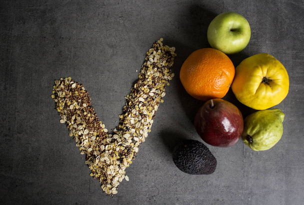 Cereals of different types and fresh fruits on dark grey background. Healthy eating concept.  - Photo, Image