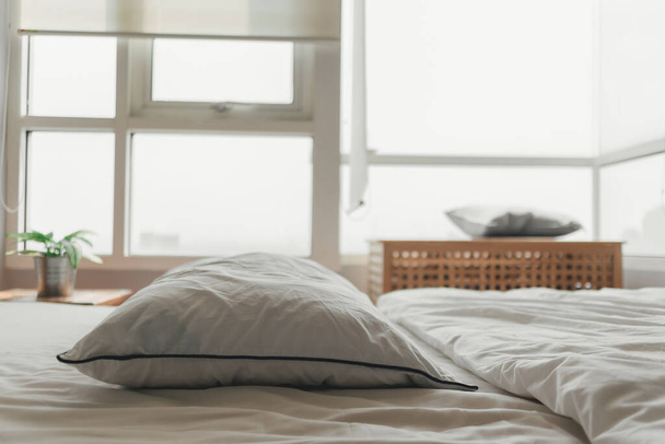 Comfortable loft white bedroom in bright day light. - Foto, imagen