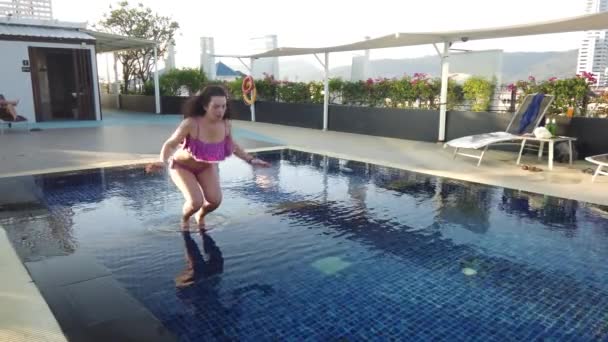 The girl swims in the hotel pool. Girl relaxes by the pool - Video