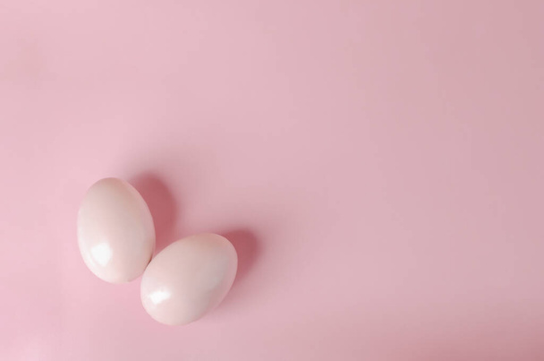 Pink pastel easter eggs on blue background - Fotó, kép