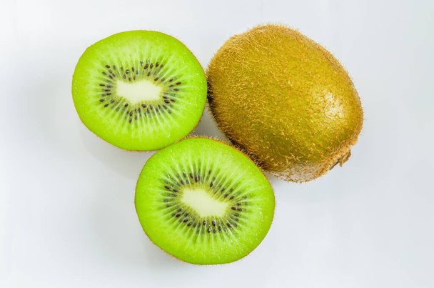 Close up of fresh kiwi fruits and kiwi slice on white background - Φωτογραφία, εικόνα