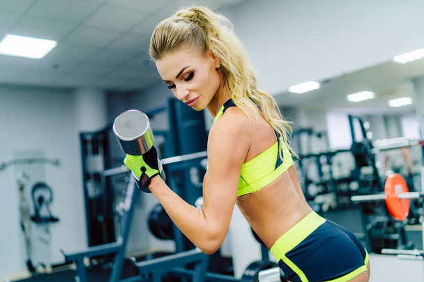Fit woman working out at the gym. Athlete and beauty doing workout. Health life sport concept. - Foto, immagini