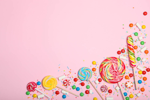 Candies and sweets on a colored background top view with place for text. - Fotó, kép