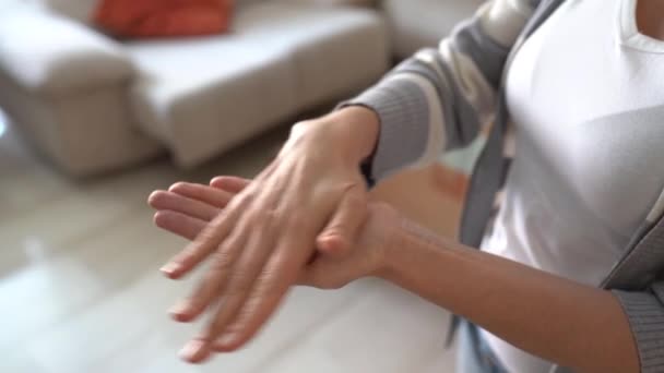 Woman using alcohol gel to clean hands during Covid-19 quarantine. - Felvétel, videó