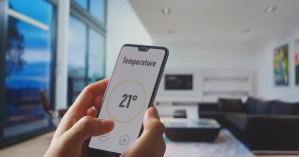 Smart home, application on the phone. A man manages various parameters of his home from a smartphone. Management of temperature, humidity and safety and security systems. Enable alarm. - Footage, Video