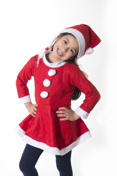 Cute Little Girl in Santa Claus costume standing happy at Xmas - Foto, Imagen