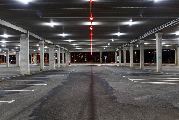 Empty car Parking in the shopping center during pandemic. People avoid public places and stay at home. The concept of pandemic, epidemic, covid-19. - Photo, Image