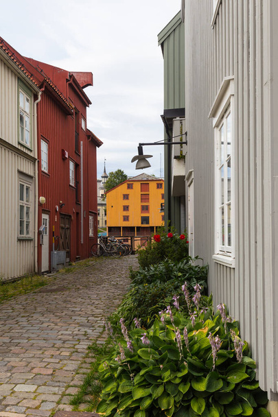 An old town's neighborhood with traditional wooden buildings in the city of Trondheim, Norway. - Photo, image