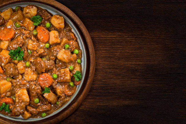 Beef Curry Stew with Potatoes and Carrots on Wooden Background. Selective focus. - Photo, Image