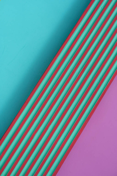 part of diagonally striped line of red green on colorful bright blue pink cement or concrete wall architecture abstract geometric background - Foto, immagini