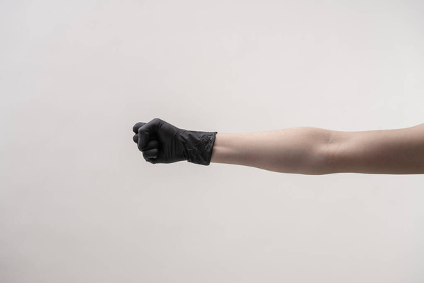 Hands in black silicone gloves on a light background. - Zdjęcie, obraz