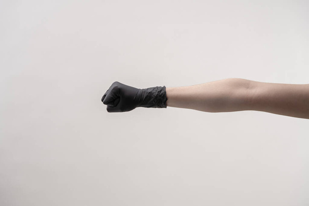 Hands in black silicone gloves on a light background. - Foto, afbeelding