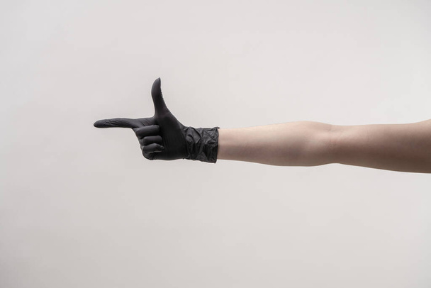 Hands in black silicone gloves on a light background. - Fotoğraf, Görsel