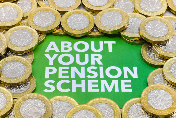 Top of a printed note with message "About your pension scheme" surrounded by piles of British one pound coins - Photo, Image
