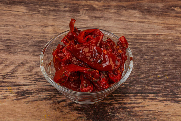 Dried tomato with olive oil and herbs - 写真・画像