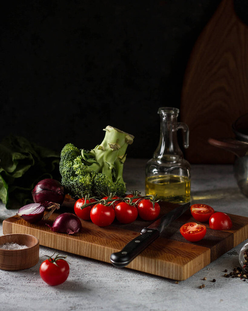 Fresh vegetables on a cutting Board, dark photo. - Photo, Image