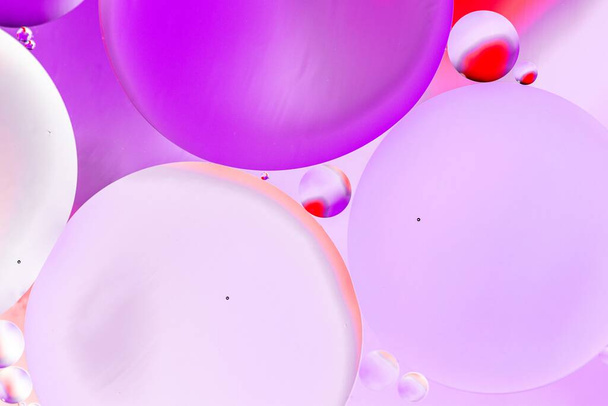 A graphic illustration of pink and purple circles on a pink background - Foto, Bild