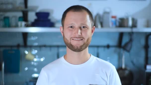 Slow motion portrait of handsome sporty guy at home smiling looking at camera. - Materiał filmowy, wideo