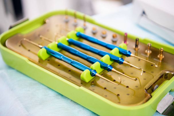 Set of dental tools for teeth care, isolated on blue background - 写真・画像