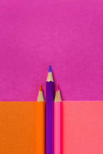 Pink color pencils on pink background. Pink designer paper. Concept of contrast opposites. - Foto, Imagem