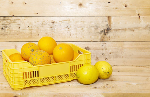 fresh arabic groupe of mandarin fruits on basket on wood table - Фото, изображение