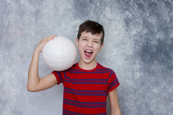 Portrait of a handsome teenage sport boy with volleyball. Workout online concept. - Photo, Image
