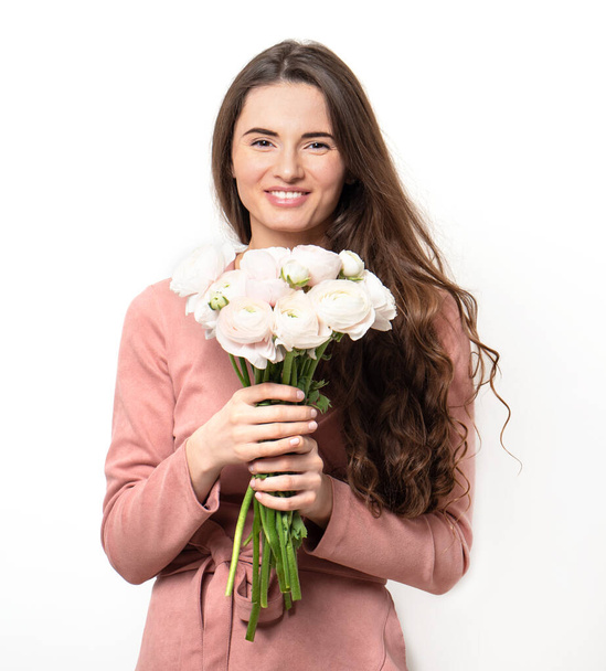 Beautiful young woman with dark long hair with a bouquet of delicate flowers . Isolated photo - Foto, Imagem