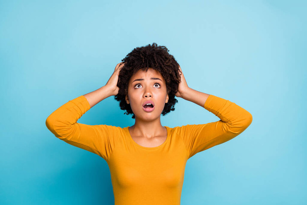 My god what should i do. Frustrated anxious afro american have many problems get fired job touch hands head look copyspace up wear stylish trendy pullover isolated blue color background - Foto, immagini