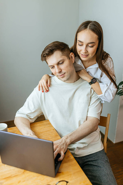 careful wife support her husband while he is working from home - Photo, Image