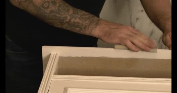 Details of the restoration of an antique piece of furniture in white with a patina effect - Footage, Video