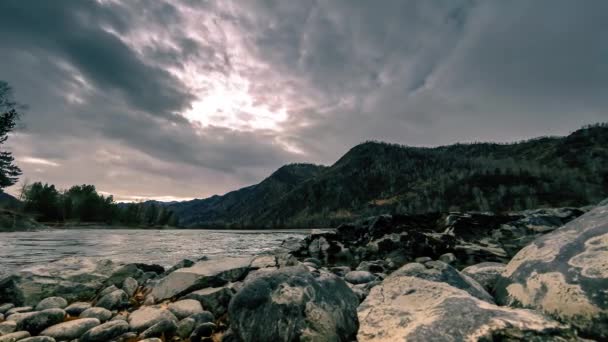 Time lapse shot of a river near mountain forest. Huge rocks and fast clouds movenings. Horizontal slider movement - Video