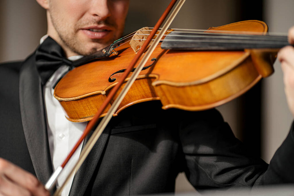 talented professional man gracefully play violin - Foto, Bild