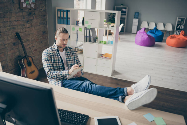 Photo of business guy computer monitor legs on table writing notes watch online webinar preparing important career meeting conference wear casual shirt sit modern office indoors - 写真・画像